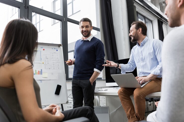 three young men and a woman in an office space